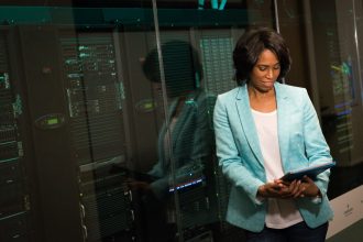 Profissional de TI examina servidores em um data center moderno.